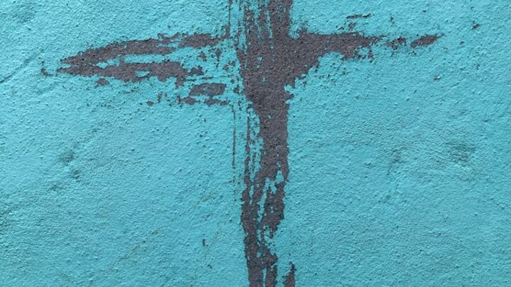 Painted cross on a blue background
